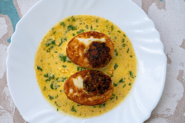 Les Oeufs Jeannette (Eggs Jeannette) with special filling and yellow sauce, vegetarian food