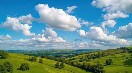 Obraz premium Serene Green Hills Under Bright Blue Sky with Fluffy Cloud Formation