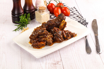 Prepared tasty beef ribs with sauce