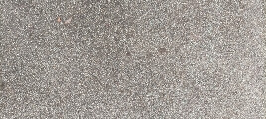 Rough asphalt surface light grey. Neutral minimal background.