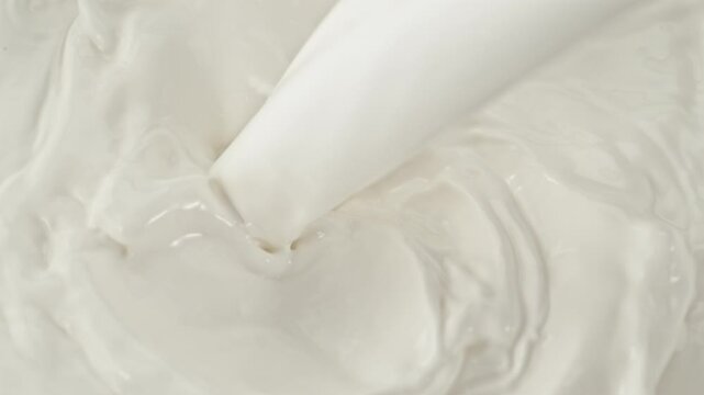 Super Slow Motion Shot of Pouring and Splashing Fresh Milk at 1000 fps.