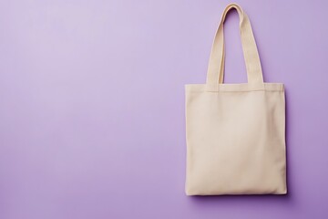 A beige tote bag on a pastel purple background