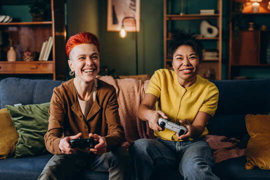 Women avid players express positive emotions playing together
