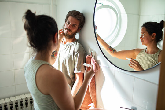 Couple celebrating positive pregnancy test in bathroom