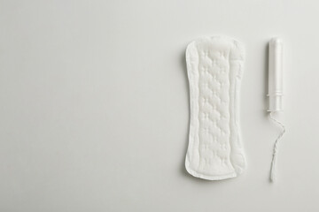 Menstrual pad and tampon on white background, top view. Space for text