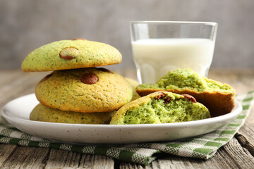 Delicious mint chocolate chip cookies and milk on wooden table, closeup