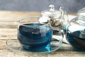 Delicious butterfly pea flower tea on wooden table, closeup
