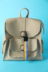 Backpack with keychain in LGBT colors on light blue background