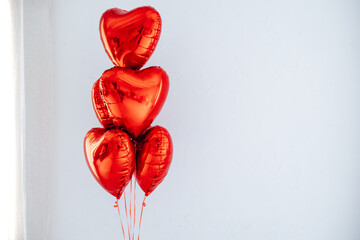 Red heart balloons on white background. Happy Valentine's Day. Love symbol. Party decoration