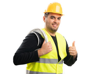 Smiling constructor holding extension cord showing thumb up
