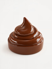 Dark chocolate swirl placed on a white surface showcasing its glossy texture and rich color