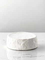 Creamy white cheese on a marble surface showcasing artisan craftsmanship and simplicity in presentation