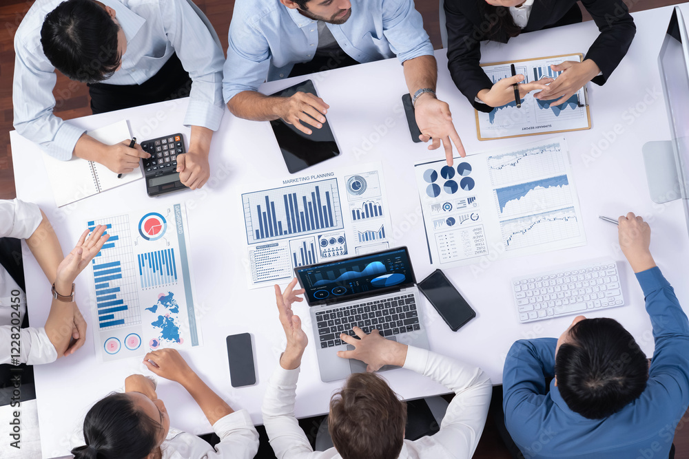 Poster Top view analyst team utilizing BI Fintech to analyze financial data at table in meeting room. Analytic BI dashboard power on paper for business insight and strategic marketing planning. Prudent