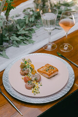 Elegant dining experience with gourmet salmon and assorted vegetable medley on a beautifully set table