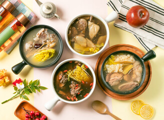 Assorted Chicken Soup include sesame oil, pineapple, bitter melon, Ginseng, Glutinous Rice with South African Tea, Red Dates and Wolfberry Tea, japanese double tea, apple, and lemon on table top view