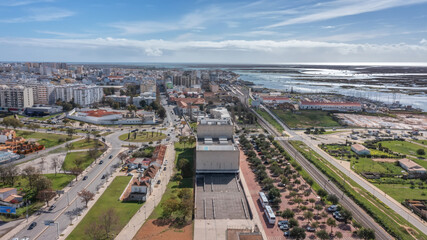 Modern Portuguese oceanfront town of Faro overlooking theater, filmed by drone. Algarve. Ria...