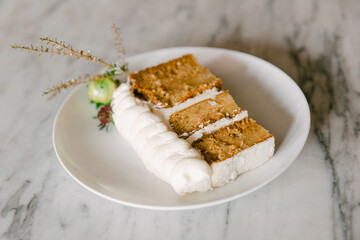 Delicious dessert featuring moist cake slices topped with creamy frosting on a stylish plate