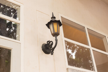 Old fashioned street light on the wall with window,Cozy house exterior,Large estate home building Window Frame,minimal home concept.