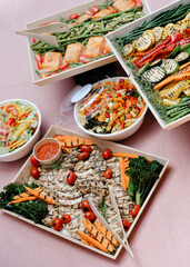 Catering display featuring healthy grilled vegetables and proteins in an outdoor setting for a summer gathering