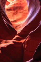 A narrow canyon with a red wall