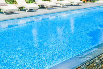 Empty swimming pool with sunbed around outdoor swimming pool in hotel resort hotel for vacation...