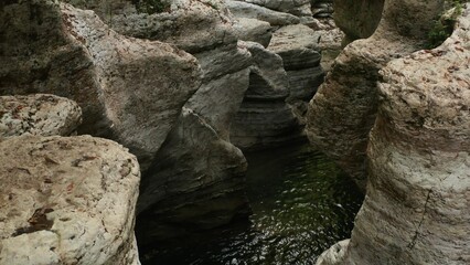 Water flowing through majestic canyon walls in a serene landscape