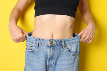 Celebrating the Successful and Transformative Weight Loss Journey with a Pair of Loose Jeans