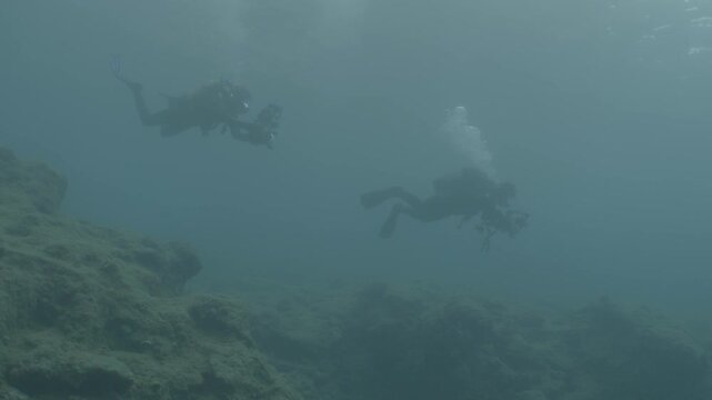 log footage of divers exploring underwater