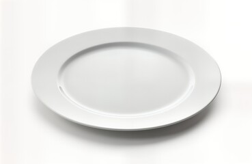 Empty white porcelain plate ready for dinner on plain white surface. Elegant, simple design. Suitable for food presentation. Ideal for home decor catering purposes. Perfect for dinner settings meal