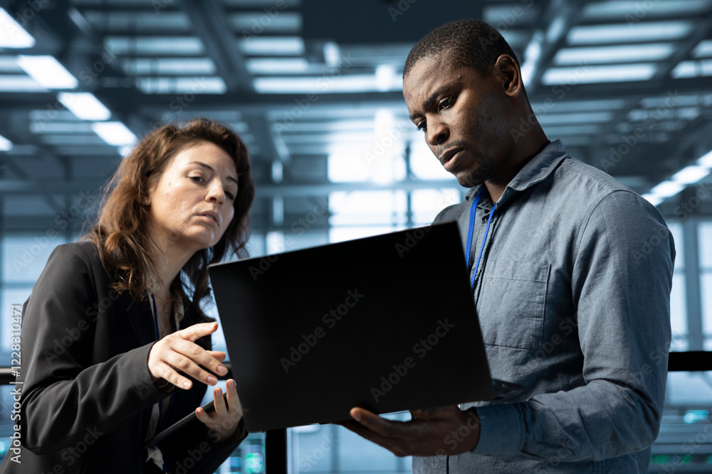 Poster team of engineers working in server farm, using laptops to analyze data. teamworking employees exami