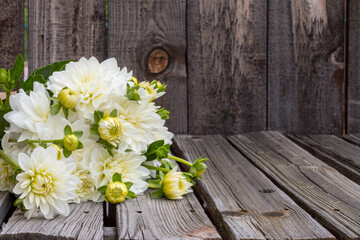 dahlias on a rustic table with room for copy