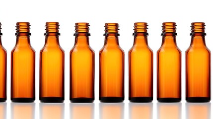 Row of empty amber glass bottles for essential oils and liquid storage on a reflective surface