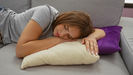 Fototapeta premium Woman sleeping peacefully on a cozy couch in a stylish living room, surrounded by pillows, captures relaxation and comfort in a home environment, conveying tranquility and rest.