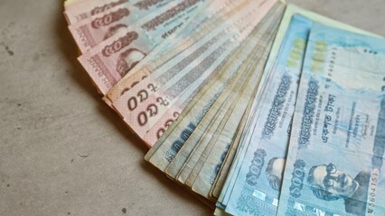Bangladeshi banknotes neatly spread on a concrete surface showcasing various denominations including taka currency from bangladesh.