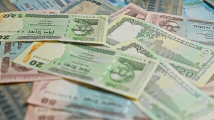 Bangladeshi banknotes showcasing various denominations are spread out, illustrating the diversity and design of bangladesh's currency.