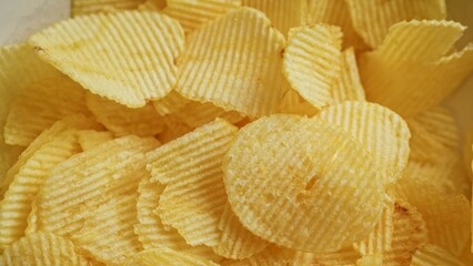 Crispy potato chips arranged in a close-up view displaying the texture and golden color of the snack