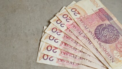 Polish banknotes of twenty zloty spread out on a concrete surface showcasing financial currency and economy related to poland.