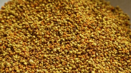 Closeup of colorful bee pollen, highlighting its granulated texture and natural colors making it ideal for health, food and wellness visuals.