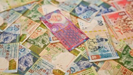 Colorful hong kong dollar banknotes spread out in a random arrangement showcasing various denominations and detailed designs