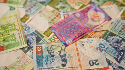 Hong kong dollar banknotes scattered in an overlapping manner, showcasing a colorful array of currency notes from hong kong.
