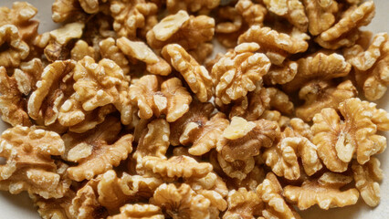 Closeup of fresh shelled walnuts in a pile highlighting their texture and natural detail