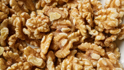 Closeup of shelled walnuts, brown and crunchy, providing a nutritious, healthy snack with detailed textures and natural appearance.