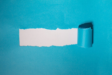 Blue torn paper. Burst hole background. Minimal abstract colorful wallpaper concept.