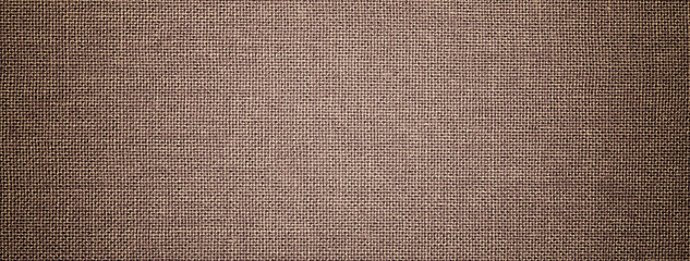 Dark brown background from hessian textile material with wicker pattern, and vignette. Structure umber fabric