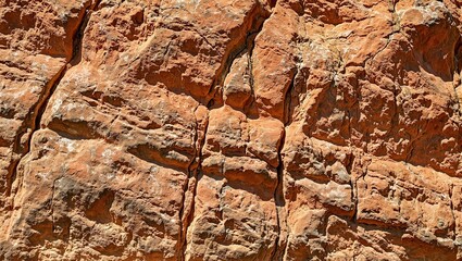 Layered rock formations in rich earthy tones with sharp defined lines