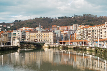 Naklejka premium Picturesque Riverside View of Bilbao with Historic Architecture
