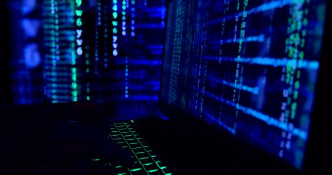 Close up of hands typing code on a laptop keyboard - codes and program software. Hacking or programming concept