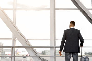Waiting For Flight. Man With Suitcase Standing Near Window At Airport Terminal, Unrecognizable Male...