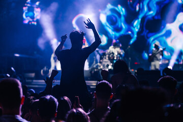 Silhouetted crowd at an exciting live music concert