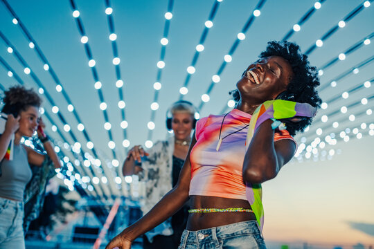 Young women dancing and enjoying music at silent disco festival